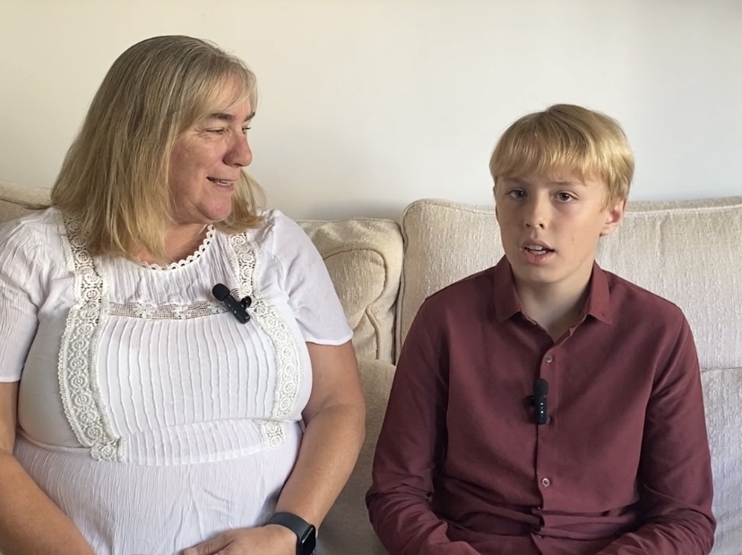 Tracy and Oliver sitting on the sofa together getting ready to be filmed for a case study