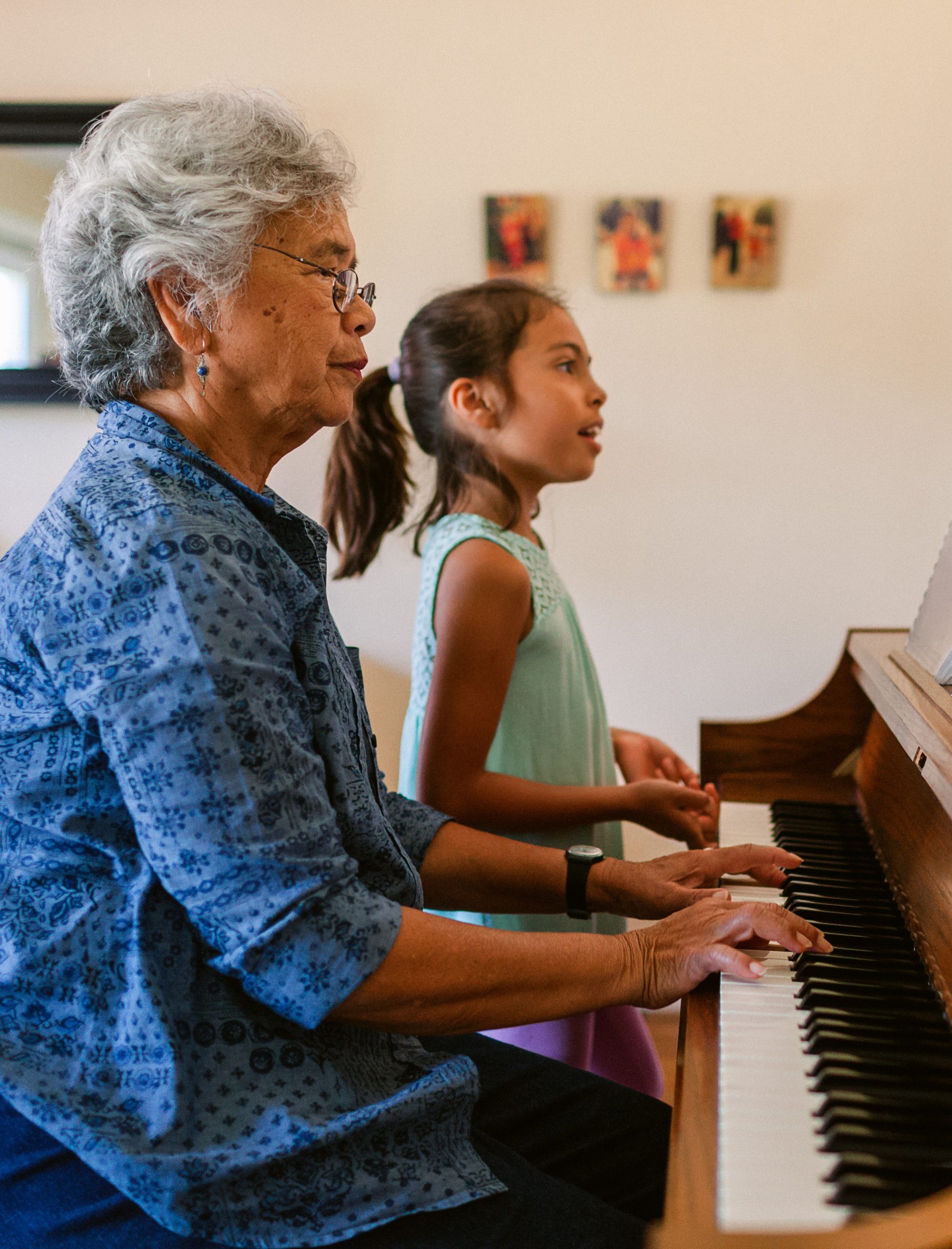 foster carer playing the piano with their fostered child