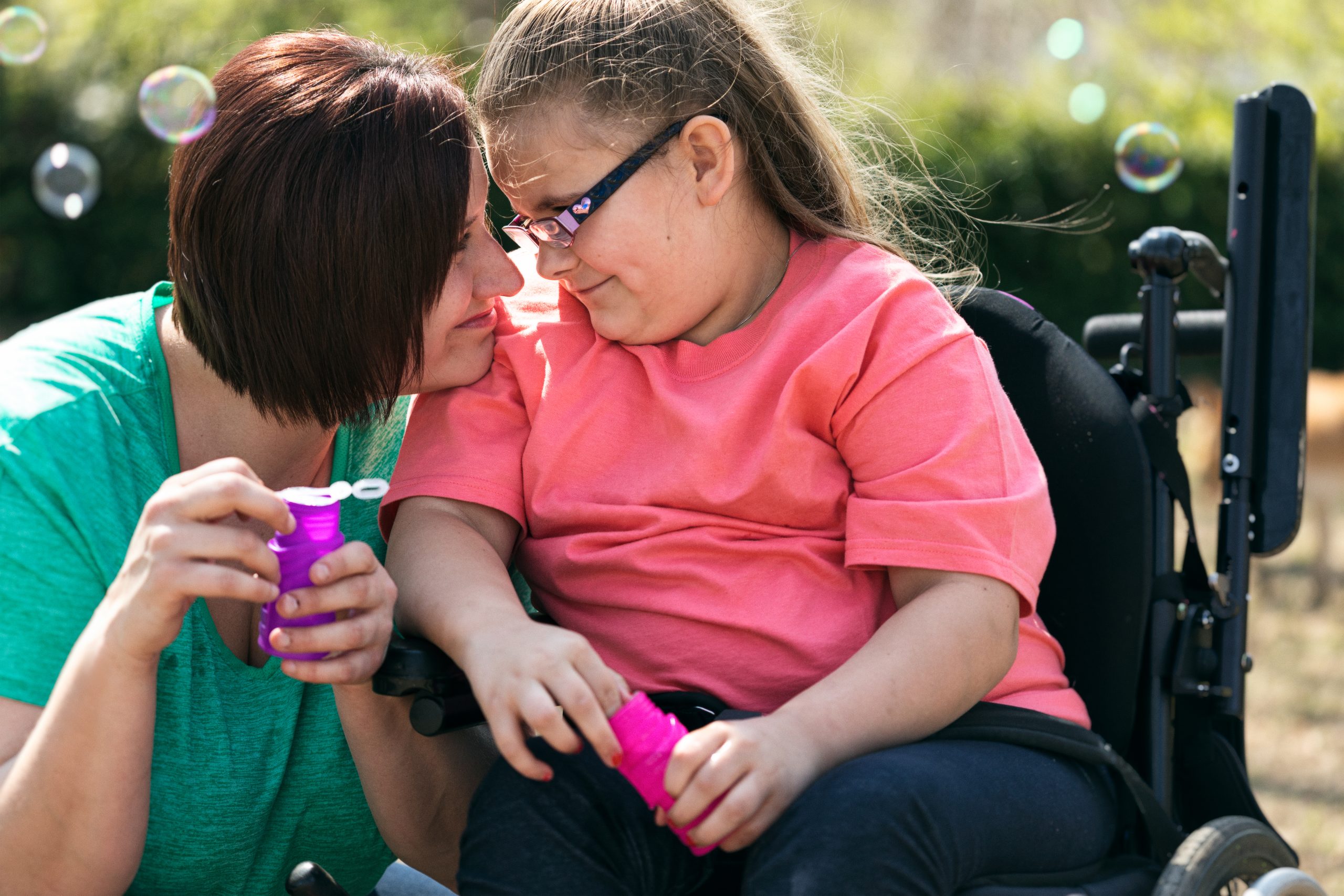 foster carer sitting next to a young person with a disability