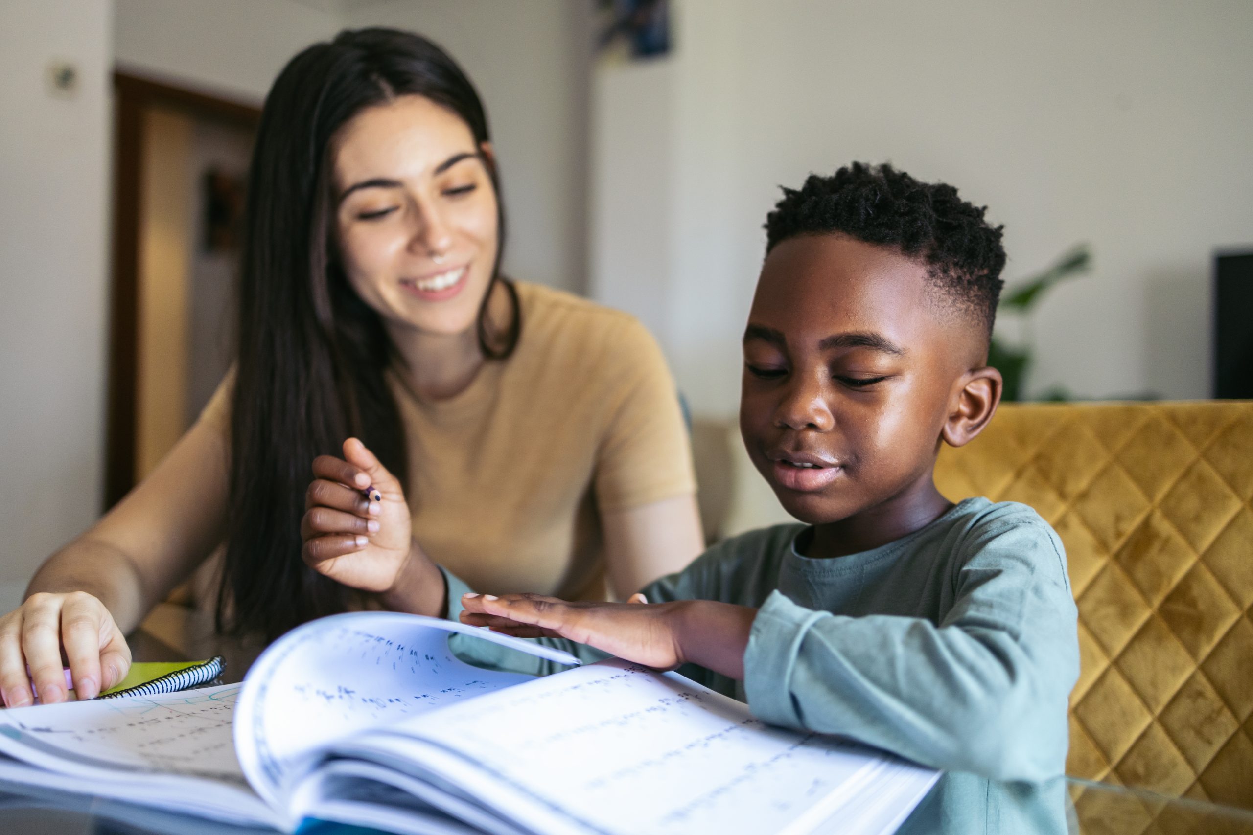 a foster carer doing homework with their fostered child
